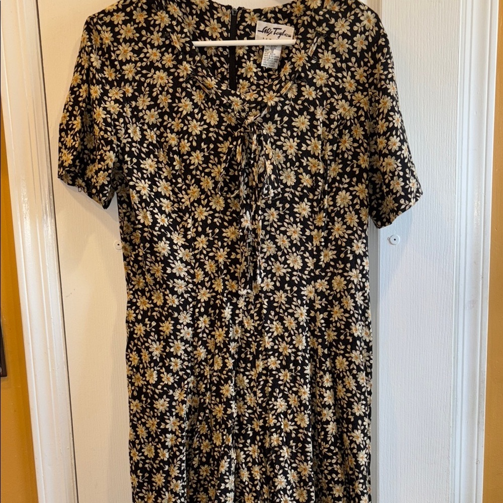 BLACK ROMPER FLORAL DESIGN 100% RAYON SIZE 14… HAS ZIPPER ON BACK
SLIT IN FRONT